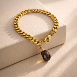 Pulsera Cadena Cubana Chapa de Oro 22k con Dije de Cuarzo Ahumado marca Cianna.